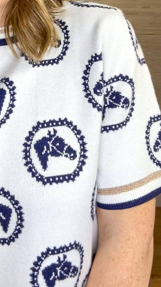 white short sleeve sweater top with navy horse pattern and metallic gold trim at neck and sleeves