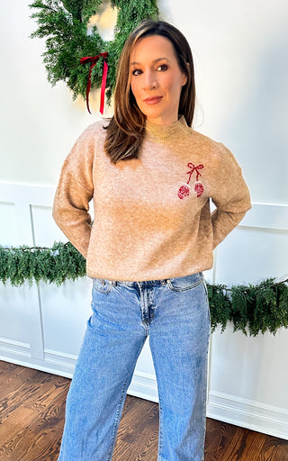 Women’s oat sweater with red mittens detail, front chest and large back graphic