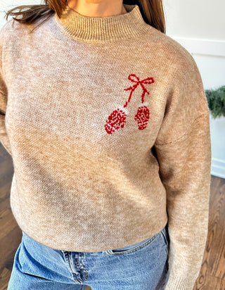 Women’s oat sweater with red mittens detail, front chest and large back graphic